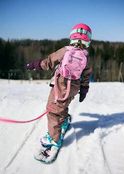 Kid snowboarding with MDXONE Harness